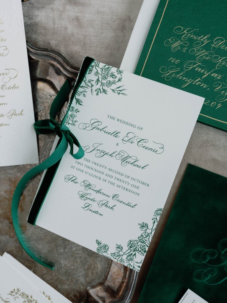 Custom wedding invitation with green  floral border and green velvet ribbon by Laura Hooper Design House