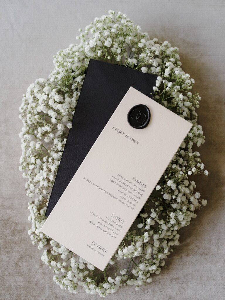 Leather backed wedding menu with custom wax seal. Custom wedding stationery & paper details. Laura Hooper Design House. 