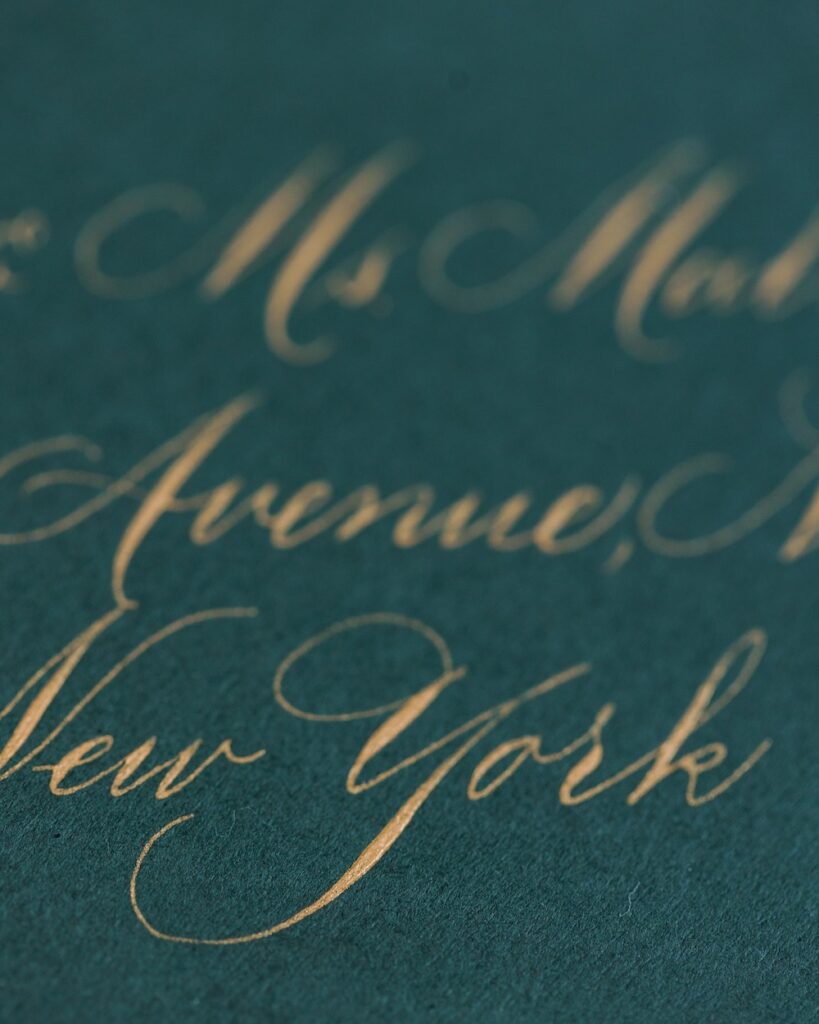 Green wedding invitation envelope with gold calligraphy address. Laura Hooper Design House.  