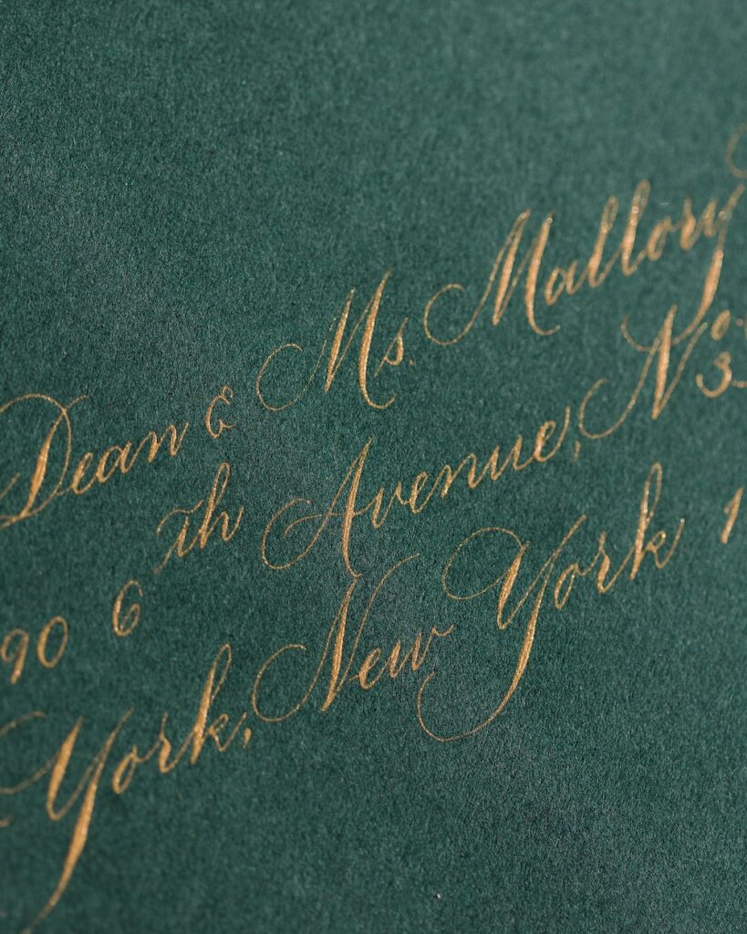 Racing green wedding invitation envelope with gold calligraphy address. Laura Hooper Design House. 