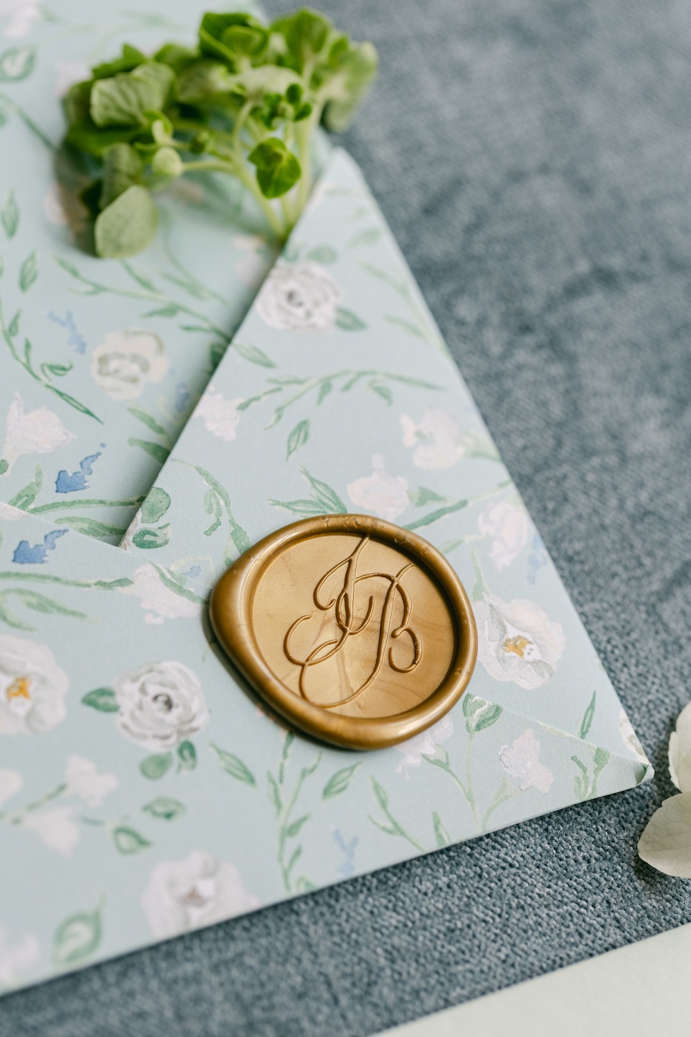 Floral watercolor pocket wrap envelope for custom wedding invitation with gold wax seal. Laura Hooper Design House