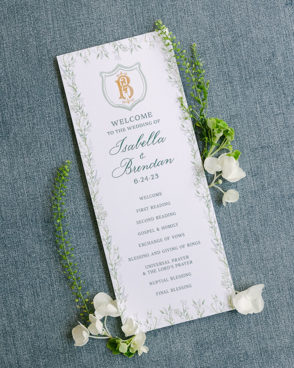 Custom watercolor flower border wedding ceremony program card with gold foil monogram. Laura Hooper Design House