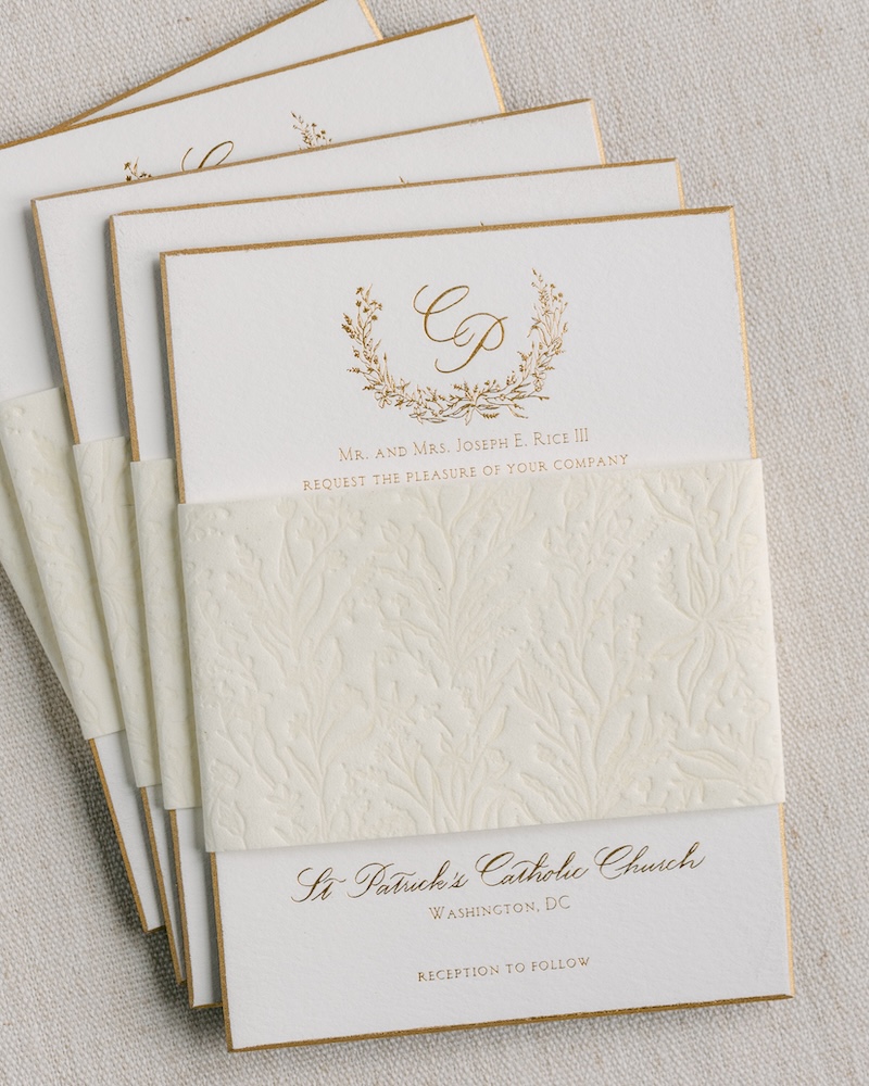 gold bevel edge wedding invitation card with gold foil printing, custom monogram design, blind deboss belly band. Laura hooper design house